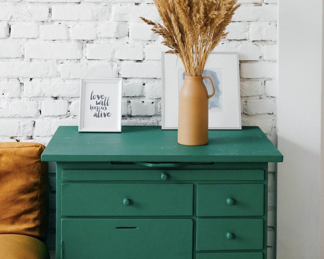 Image of a green drawer with photo frames on top