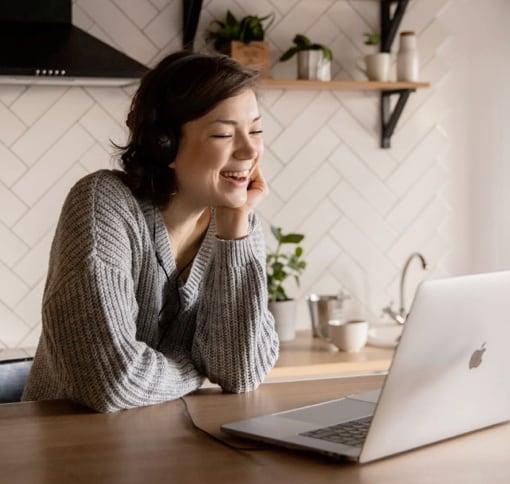 Woman looking into a laptop on a video call